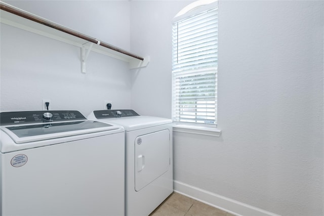 8926 Rollick Dr, Tomball, TX 77375 - laundry room featuring separate washer and dryer, light tile patterned floors, and baseboards