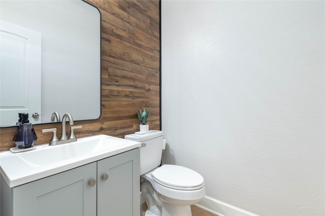 8926 Rollick Dr, Tomball, TX 77375 - bathroom featuring baseboards, toilet, vanity, and wooden walls