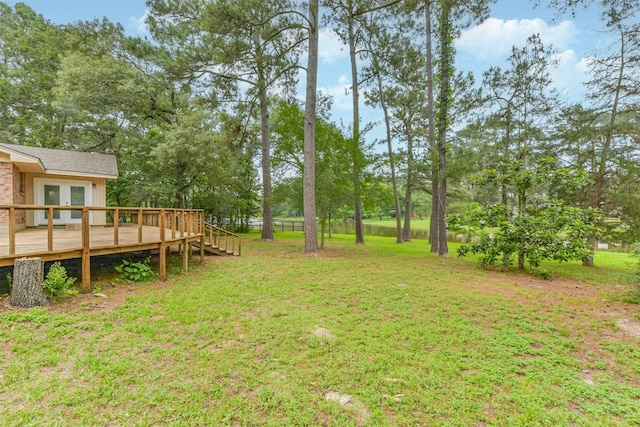 29090 W Lake Dr, Hempstead, TX 77445 - view of grassy yard featuring a deck, french doors, and view of scattered trees