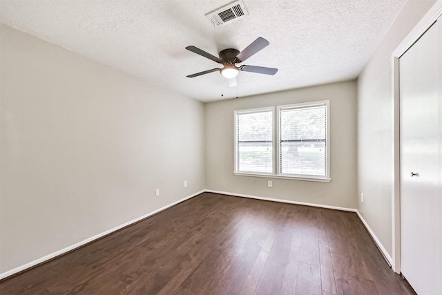 29090 W Lake Dr, Hempstead, TX 77445 - unfurnished bedroom featuring dark wood-style flooring, a textured ceiling, baseboards, and a ceiling fan