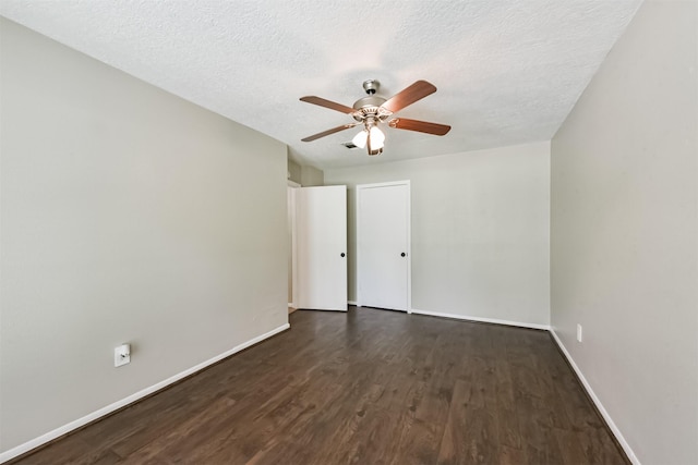 29090 W Lake Dr, Hempstead, TX 77445 - unfurnished room with dark wood-style flooring, baseboards, a textured ceiling, and a ceiling fan