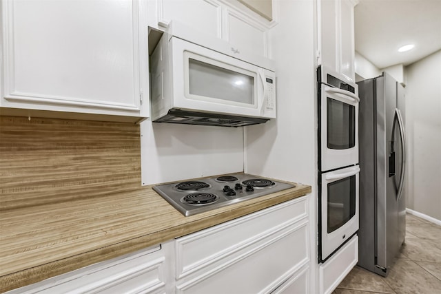 29090 W Lake Dr, Hempstead, TX 77445 - kitchen with appliances with stainless steel finishes, white cabinetry, light tile patterned floors, and light countertops