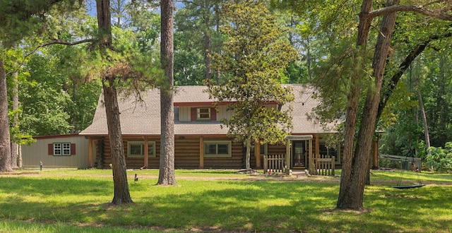 38614 Angel Oaks Dr, Magnolia, TX 77355 - back of property with log siding, a yard, roof with shingles, and covered porch