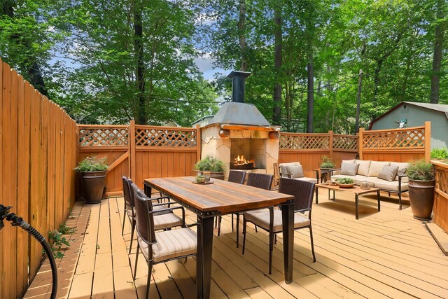 38614 Angel Oaks Dr, Magnolia, TX 77355 - wooden deck with an outdoor living space with a fireplace and outdoor dining area