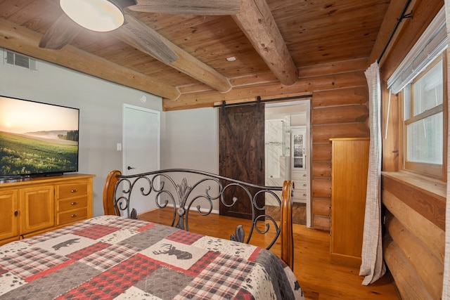 38614 Angel Oaks Dr, Magnolia, TX 77355 - bedroom featuring log walls, wood ceiling with exposed beams, a barn door, and wood finished floors