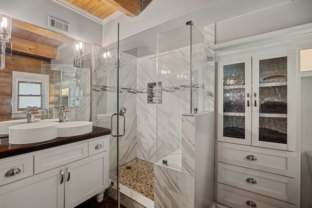 38614 Angel Oaks Dr, Magnolia, TX 77355 - bathroom with a marble finish shower, vanity, beam ceiling, and crown molding