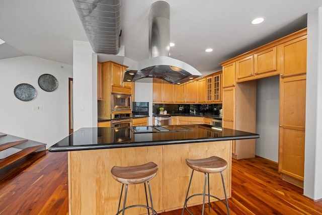 3030 Post Oak Blvd Unit 615, Houston, TX 77056 - kitchen with stainless steel appliances, island exhaust hood, dark wood-type flooring, a kitchen island, and dark countertops