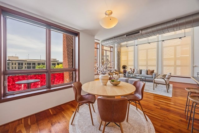 3030 Post Oak Blvd Unit 615, Houston, TX 77056 - dining room featuring wood finished floors and floor to ceiling windows