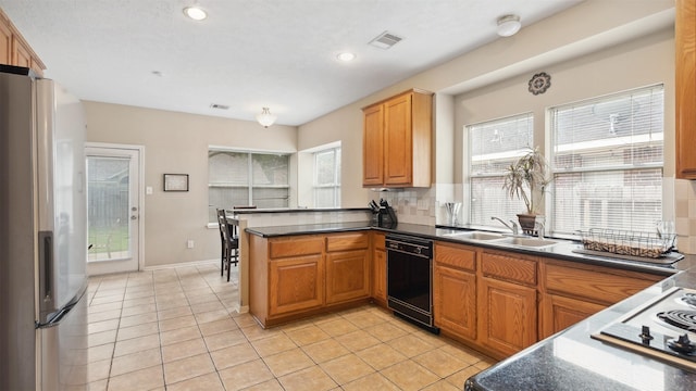 9618 Mystic Crossing Ct, Houston, TX 77065 - kitchen featuring freestanding refrigerator, dishwasher, a sink, dark countertops, and a peninsula