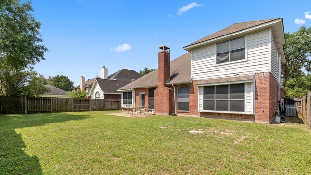9618 Mystic Crossing Ct, Houston, TX 77065 - rear view of house with brick siding, a patio, a chimney, a shingled roof, and central air condition unit