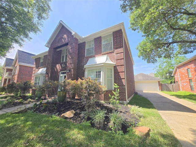 traditional-style house featuring brick siding and fence