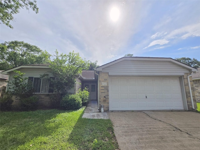 2922 Whetrock Ln, Sugar Land, TX 77479 - ranch-style home with driveway, an attached garage, brick siding, and a front yard