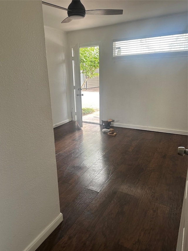 unfurnished room with hardwood / wood-style flooring, ceiling fan, baseboards, and a textured wall