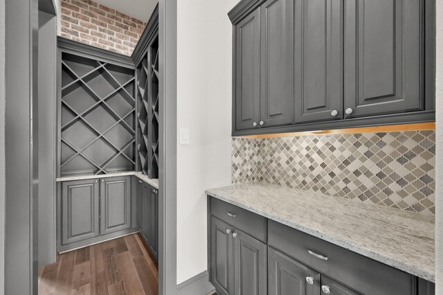 2331 Bottlebrush Ln, Conroe, TX 77384 - bar with dark wood-style floors and tasteful backsplash