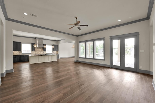 2331 Bottlebrush Ln, Conroe, TX 77384 - unfurnished living room featuring ornamental molding, ceiling fan, dark wood-type flooring, baseboards, and french doors