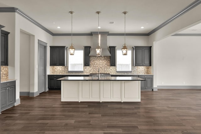 2331 Bottlebrush Ln, Conroe, TX 77384 - kitchen featuring wall chimney exhaust hood, crown molding, dark wood finished floors, backsplash, and recessed lighting