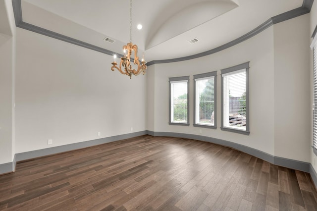 2331 Bottlebrush Ln, Conroe, TX 77384 - spare room with a chandelier, dark wood-type flooring, lofted ceiling, ornamental molding, and baseboards