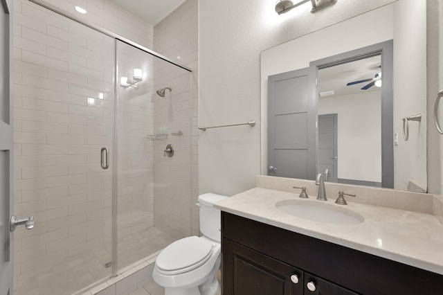 2331 Bottlebrush Ln, Conroe, TX 77384 - bathroom featuring a shower stall, toilet, ceiling fan, and vanity