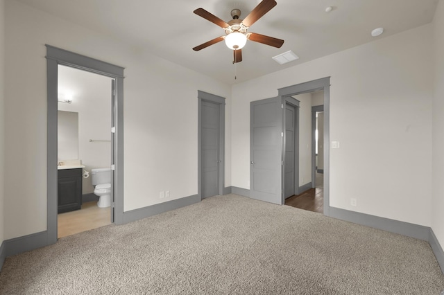 2331 Bottlebrush Ln, Conroe, TX 77384 - unfurnished bedroom featuring carpet flooring, baseboards, ensuite bathroom, and a ceiling fan