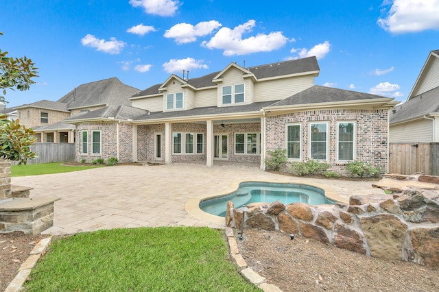 2331 Bottlebrush Ln, Conroe, TX 77384 - rear view of property featuring a fenced backyard, brick siding, a patio area, and a shingled roof