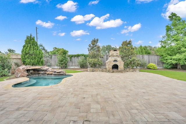 2331 Bottlebrush Ln, Conroe, TX 77384 - view of pool with an outdoor stone fireplace, a fenced backyard, and a patio