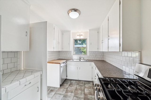 2740 Suffolk Dr, Houston, TX 77027 - kitchen with appliances with stainless steel finishes, backsplash, white cabinets, and a sink
