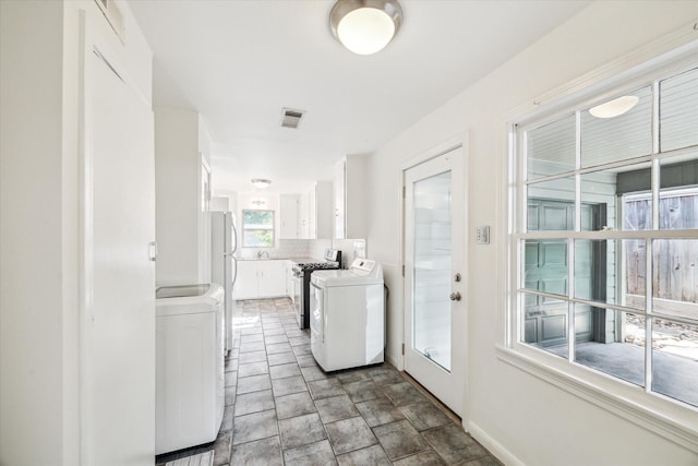 2740 Suffolk Dr, Houston, TX 77027 - laundry room with baseboards and stone finish flooring