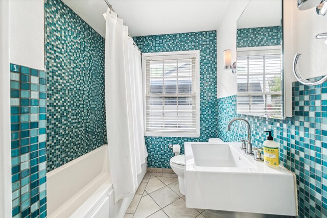 2740 Suffolk Dr, Houston, TX 77027 - bathroom with tile walls, tile patterned flooring, shower / tub combo, toilet, and a sink