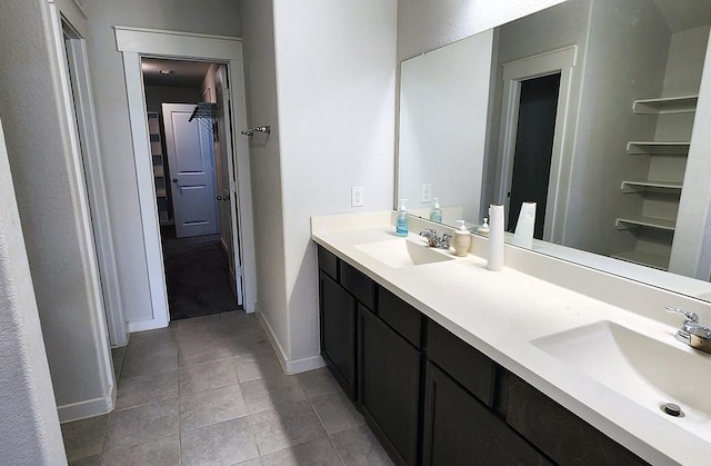 16342 Rockdale Landing Dr, Hockley, TX 77447 - bathroom with tile patterned floors, double vanity, a walk in closet, and baseboards