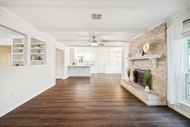 10014 Moorberry Ln, Houston, TX 77080 - unfurnished living room with crown molding, a fireplace, ceiling fan, dark wood-type flooring, and beam ceiling