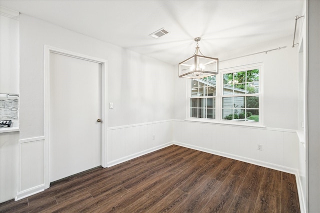 10014 Moorberry Ln, Houston, TX 77080 - unfurnished dining area with dark wood-style floors, a chandelier, and wainscoting