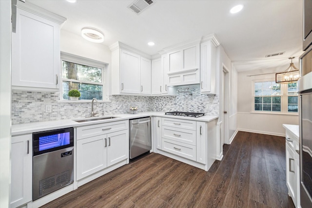 10014 Moorberry Ln, Houston, TX 77080 - kitchen with dishwasher, a sink, gas cooktop, light countertops, and dark wood-style floors