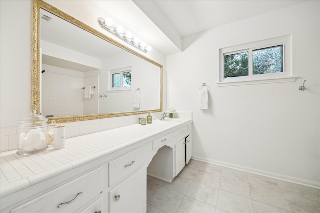 10014 Moorberry Ln, Houston, TX 77080 - bathroom with vanity, baseboards, a tile shower, and tile patterned flooring