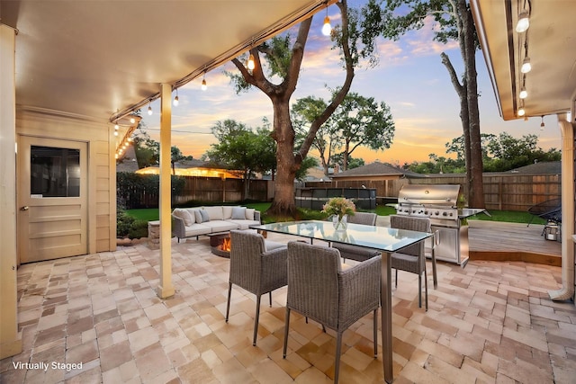 10014 Moorberry Ln, Houston, TX 77080 - patio terrace at dusk with a fenced backyard, a deck, an outdoor hangout area, outdoor dining area, and a grill