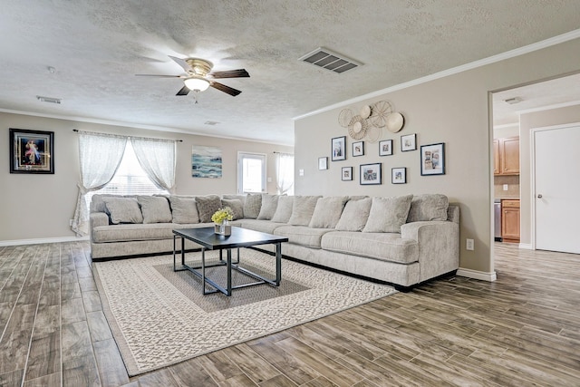 10911 Crosby Field Ln, Houston, TX 77034 - living room with a ceiling fan, wood finished floors, crown molding, a textured ceiling, and baseboards