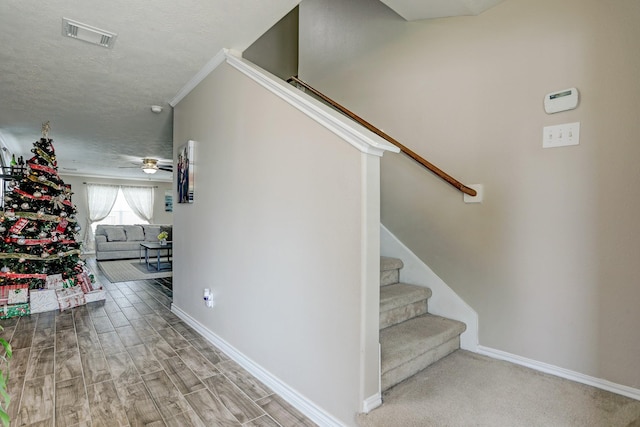 10911 Crosby Field Ln, Houston, TX 77034 - staircase with baseboards, a textured ceiling, a ceiling fan, and wood finished floors