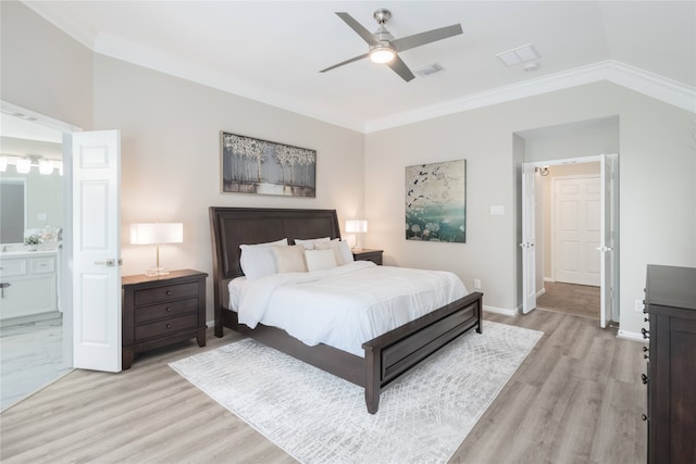 bedroom featuring crown molding, light wood-type flooring, baseboards, a ceiling fan, and ensuite bathroom