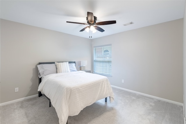 bedroom featuring light carpet, baseboards, and a ceiling fan