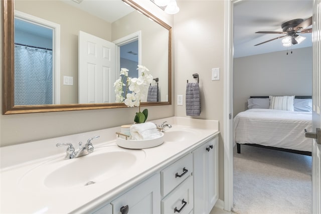 bathroom featuring double vanity, ceiling fan, and ensuite bath