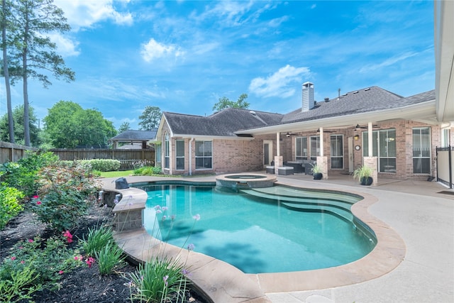 view of swimming pool featuring a patio area, ceiling fan, a fenced backyard, and a pool with connected hot tub