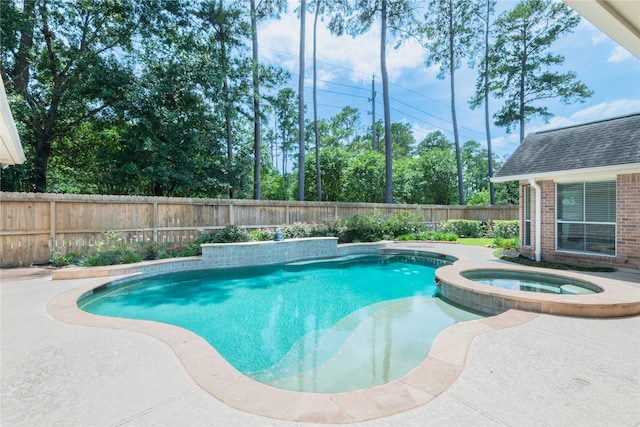 view of pool with a fenced backyard and a pool with connected hot tub