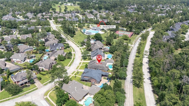 aerial view of property and surrounding area with a pool and nearby suburban area