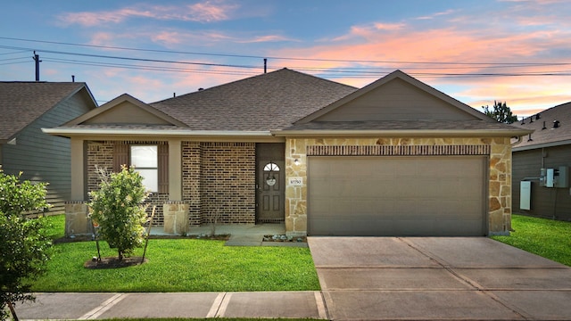 10750 Nathaniel Valley Path, Houston, TX 77016 - single story home featuring roof with shingles, an attached garage, driveway, a yard, and brick siding