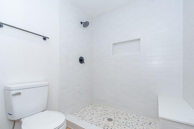2425 E Fayle St, Baytown, TX 77521 - bathroom featuring toilet and a tile shower