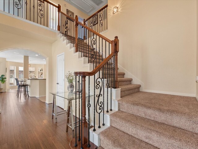 22603 Blanefield Ct, Tomball, TX 77375 - stairs with arched walkways, wood finished floors, baseboards, and a towering ceiling