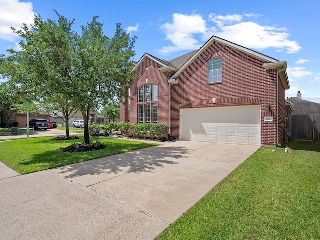 traditional-style house with concrete driveway, brick siding, an attached garage, and a front lawn