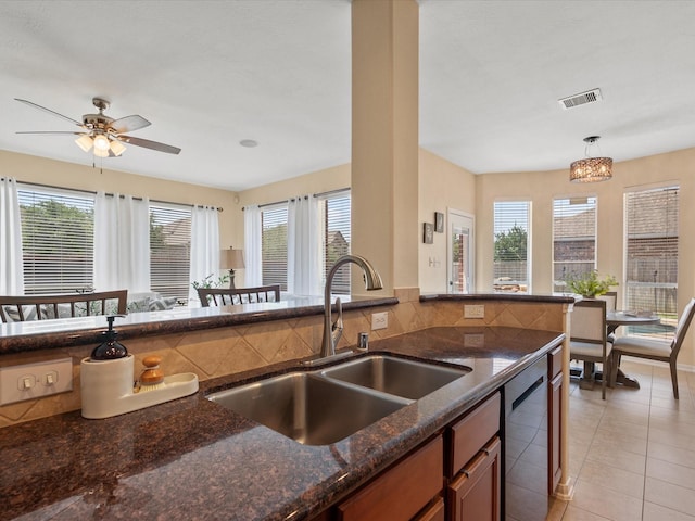 22603 Blanefield Ct, Tomball, TX 77375 - kitchen with a sink, plenty of natural light, dishwasher, and dark stone counters