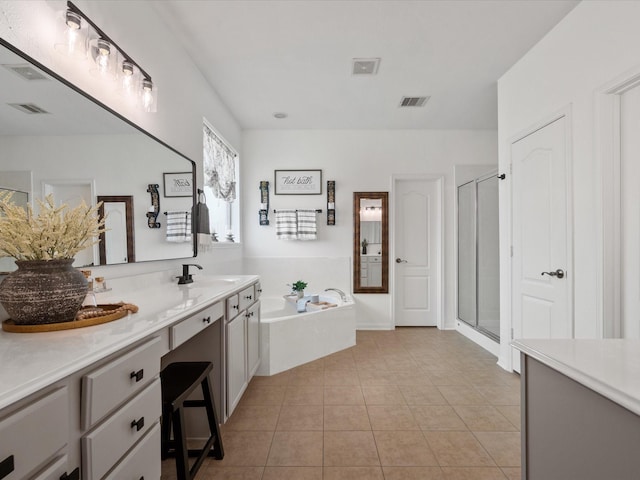 22603 Blanefield Ct, Tomball, TX 77375 - bathroom with vanity, a garden tub, a shower stall, and tile patterned floors