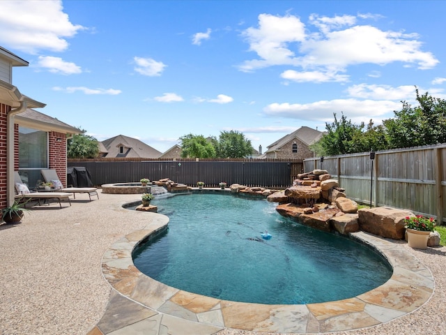 view of pool with a fenced backyard, a patio area, and a pool with connected hot tub