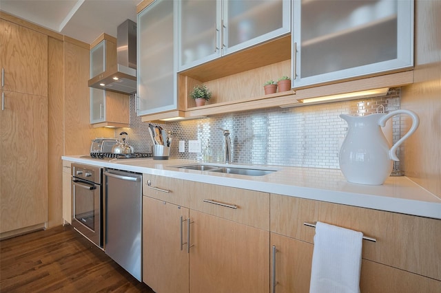 2207 Bancroft St Unit 604, Houston, TX 77027 - kitchen featuring wall chimney range hood, light brown cabinetry, appliances with stainless steel finishes, a sink, and light countertops